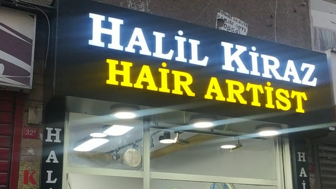 The illuminated sign of Halil Kiraz Hair Artist barbershop in Fatih, Istanbul